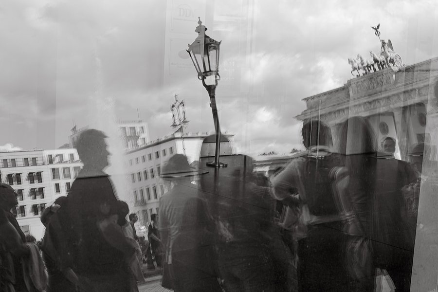 Reflejos de personas y arquitectura en un cristal